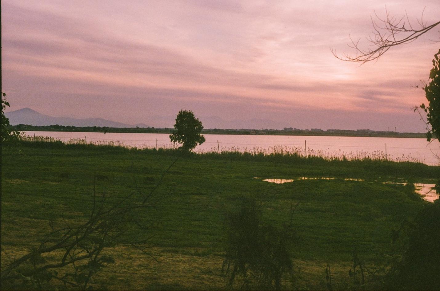 Pink and orange sunset over lake